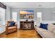 Relaxing living room with a cozy fireplace, hardwood floors, comfortable seating, and coastal-themed decor at 138 Marblehead Dr., Little River, SC 29566