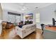 Cozy living room with hardwood floors, comfortable seating, a ceiling fan, and an entertainment center with a beach scene at 138 Marblehead Dr., Little River, SC 29566