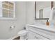 Clean powder room with a pedestal sink, modern fixtures, a vanity mirror, and a window with blinds at 138 Marblehead Dr., Little River, SC 29566