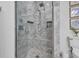Detailed view of the shower with marble-like tiles and dual shower heads in the bathroom at 138 Marblehead Dr., Little River, SC 29566