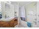 Bathroom with a shower-tub combo, wood vanity, and a view into the connected bedroom at 1420 S Ocean Blvd., North Myrtle Beach, SC 29582