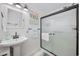 Bathroom features a pedestal sink, glass shower, and neutral color scheme at 1420 S Ocean Blvd., North Myrtle Beach, SC 29582