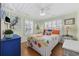 Comfortable bedroom with ample natural light, wood floors, and coastal-themed artwork at 1420 S Ocean Blvd., North Myrtle Beach, SC 29582