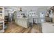 Bright kitchen with island, stainless steel appliances, and wooden floors throughout at 1420 S Ocean Blvd., North Myrtle Beach, SC 29582
