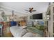 Cozy living room featuring a large TV, ceiling fan, and comfortable seating at 1420 S Ocean Blvd., North Myrtle Beach, SC 29582