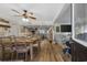 Open-concept living and dining area with wood floors, a ceiling fan and natural light at 1420 S Ocean Blvd., North Myrtle Beach, SC 29582
