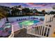 Outdoor pool area with lounge chairs, tables, and a hot tub for ultimate relaxation at 1420 S Ocean Blvd., North Myrtle Beach, SC 29582