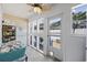 Bright sun room with tiled walls, a ceiling fan, and access to an outdoor pool area at 1420 S Ocean Blvd., North Myrtle Beach, SC 29582