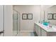 Bathroom with dual sinks, framed art, walk-in shower, and white cabinets for ample storage space at 1431 Porchfield Dr., Conway, SC 29526