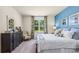 Stylish bedroom features a decorative dresser, patterned chair, and large window with scenic view at 1431 Porchfield Dr., Conway, SC 29526