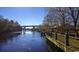 Scenic riverwalk featuring a bridge and walkway, surrounded by lush greenery and sparkling water at 1431 Porchfield Dr., Conway, SC 29526
