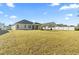 Expansive backyard featuring manicured lawn and mature trees, providing ample space for outdoor activities at 145 Copper Leaf Dr., Myrtle Beach, SC 29588