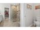 Bright bathroom showcasing a glass enclosed shower, tile flooring, and access to walk in closet at 145 Copper Leaf Dr., Myrtle Beach, SC 29588