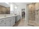 Bright bathroom featuring double sinks, vanity, large glass shower, and walk in closet access at 145 Copper Leaf Dr., Myrtle Beach, SC 29588