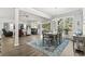 Open-concept dining room with a modern chandelier, plenty of natural light, and an area rug at 145 Copper Leaf Dr., Myrtle Beach, SC 29588