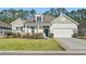 Charming single Gathering home with manicured lawn, blue front door, and neutral color palette at 145 Copper Leaf Dr., Myrtle Beach, SC 29588