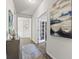 Bright hallway with wood floors, leading to rooms with a view into the library at 145 Copper Leaf Dr., Myrtle Beach, SC 29588