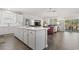 Open-concept kitchen featuring white cabinets, stainless steel appliances, and an island with a view into the living area at 145 Copper Leaf Dr., Myrtle Beach, SC 29588