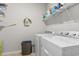 Functional laundry room with washer, dryer, shelving, and plenty of space for laundry tasks at 145 Copper Leaf Dr., Myrtle Beach, SC 29588