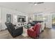 Open-concept living room with a large entertainment center, ceiling fan, and lots of natural light at 145 Copper Leaf Dr., Myrtle Beach, SC 29588