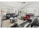 Open-concept living room with a ceiling fan, lots of natural light, and a view into the dining room at 145 Copper Leaf Dr., Myrtle Beach, SC 29588