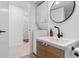 Modern bathroom featuring a stackable washer/dryer and round mirror at 1500 Cenith Dr. # C-103, North Myrtle Beach, SC 29582
