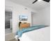 Bright bedroom featuring a TV, dresser, and a peek into the modern shower at 1500 Cenith Dr. # C-103, North Myrtle Beach, SC 29582