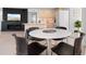 Open-concept living space with a modern table and seating, seamlessly connecting the kitchen and living areas at 1500 Cenith Dr. # C-103, North Myrtle Beach, SC 29582
