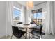 Bright dining area with modern table, chairs, and access to a screened-in porch for relaxed entertaining at 1500 Cenith Dr. # C-103, North Myrtle Beach, SC 29582