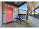 Inviting condo entrance with a pink door, bench, and yellow table on a covered walkway at 1500 Cenith Dr. # C-103, North Myrtle Beach, SC 29582