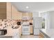 Well-lit kitchen with white countertops, wooden cabinets, and a unique backsplash design at 1500 Cenith Dr. # C-103, North Myrtle Beach, SC 29582