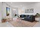 Stylish living room featuring a comfortable sofa, accent chair, and access to a private balcony at 1500 Cenith Dr. # C-103, North Myrtle Beach, SC 29582