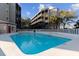 Community pool surrounded by condos, palm trees, and pool rules sign at 1500 Cenith Dr. # C-103, North Myrtle Beach, SC 29582