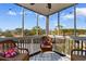 Charming sunroom with wicker furniture overlooking a golf course view at 1500 Cenith Dr. # C-103, North Myrtle Beach, SC 29582