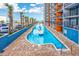 Exterior view of a building overlooking a long pool at 1501 S Ocean Blvd. # 1406, Myrtle Beach, SC 29577