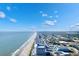 Wide aerial view showcasing the beach, hotels, and condos along the coastline under a stunning blue sky at 1501 S Ocean Blvd. # 633, Myrtle Beach, SC 29577