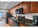 Well-equipped kitchen with black appliances, wood cabinetry, and ocean views at 1501 S Ocean Blvd. # 633, Myrtle Beach, SC 29577