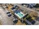 Aerial view of community pool with palm trees, lounge chairs, parking and nearby condo buildings at 160 Lazy Willow Ln. # 204, Myrtle Beach, SC 29577