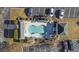 Aerial view of the community pool with surrounding lounge chairs, palm trees, and a covered gazebo area at 160 Lazy Willow Ln. # 204, Myrtle Beach, SC 29577