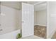 Bright bathroom features a white tub, tiled floor and a decorative plant, creating a clean and inviting space at 160 Lazy Willow Ln. # 204, Myrtle Beach, SC 29577