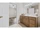 Bathroom with tile floors, wood vanity, white counter, and door to bedroom at 160 Lazy Willow Ln. # 204, Myrtle Beach, SC 29577