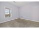 Small bedroom with neutral carpet and paint, white trim and a large window for natural light at 160 Lazy Willow Ln. # 204, Myrtle Beach, SC 29577