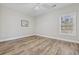 Bedroom with wood-look floors, ceiling fan and a large window at 160 Lazy Willow Ln. # 204, Myrtle Beach, SC 29577