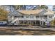 Exterior view of the condos featuring balconies, white railings, and ample parking spots for residents at 160 Lazy Willow Ln. # 204, Myrtle Beach, SC 29577