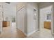 Hallway view with tile flooring, closets, and a glimpse into a bathroom and open living space at 160 Lazy Willow Ln. # 204, Myrtle Beach, SC 29577