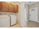 Functional laundry room featuring a washer, dryer, and overhead cabinets for ample storage space in a convenient location at 160 Lazy Willow Ln. # 204, Myrtle Beach, SC 29577