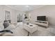 Bright living room features neutral decor, a glass sliding door, tile flooring, and a comfortable seating arrangement at 160 Lazy Willow Ln. # 204, Myrtle Beach, SC 29577