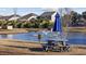 Scenic pond view with a fountain, picnic table under a blue umbrella, and lush landscaping at 160 Lazy Willow Ln. # 204, Myrtle Beach, SC 29577