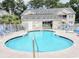 Sparkling outdoor pool with lounge chairs, a covered area, and well-maintained surroundings at 160 Lazy Willow Ln. # 204, Myrtle Beach, SC 29577