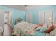 A bright bedroom with a ceiling fan, blue walls, and a queen-size bed decorated with seashells at 1608 25Th Ave. N, North Myrtle Beach, SC 29582